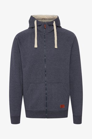 Men's hooded zip-up sweatshirt in dark gray fleece. Features cream drawstrings, front pockets, and a small brown leather logo patch.