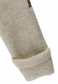 Hellbeiger Wollärmel mit weicher, strukturierter Oberfläche; ausgestattet mit einem umgeschlagenen Bündchen und einer genähten Naht für Langlebigkeit. Kleines Lederetikett angebracht.