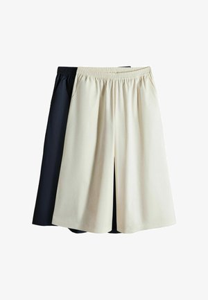 Zwei Paar Hosen mit weitem Bein und elastischem Bund, eines vorne beige und eines hinten schwarz, flach auf weißem Hintergrund dargestellt.