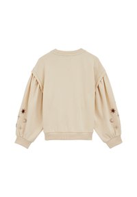 Felpa color crema con maniche a sbuffo, polsini a costine e design celestiali ricamati in oro e marrone sulle maniche.
