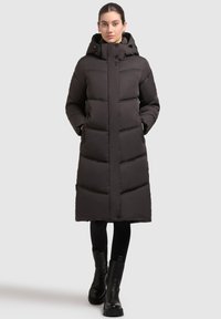 Black, long puffer coat with a hood, featuring a quilted design, front buttons, and side pockets; made from a smooth, insulated material.