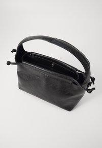 Black leather handbag with a smooth texture, rectangular shape, top handle, and tied closure. Interior is spacious. No visible hardware.