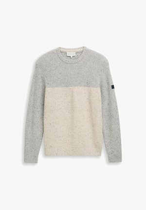 Garš sleeve adīts džemperis ar gaiši pelēku augšdaļu un piedurknēm, kā arī krēmkrāsas apakšējo daļu, ribota aproce un apakšmalā.