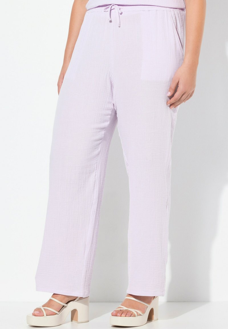 Licht paarse wijde pantalon gemaakt van een gestructureerd materiaal met een trekkoord in de taille en zijzakken, gecombineerd met lichte platform sandalen.