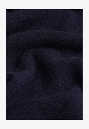 Tessuto di lana blu scuro con una superficie morbida e testurizzata, che presenta un aspetto liscio e leggermente peloso, con sottili variazioni di tonalità.