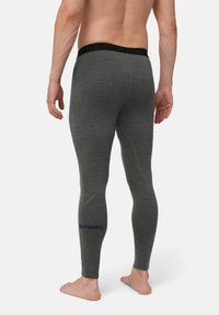 Szare legginsy termiczne z czarnym pasem w talii oraz niebieskim logo "EXTREME" na dolnej części nogawki. Materiał wygląda na miękki i elastyczny.