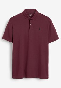 Burgundy-paitainen polo-paita, joka on valmistettu pehmeästä puuvillasta. Siinä on klassinen kaulus, kaksiknoppi pääntie ja pieni musta logo rinnassa. Normaali istuvuus.