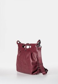 Burgunderfarbene Lederhandtasche mit einem lässigen Design, ausgestattet mit zwei durchbrochenen Griffen und einem verstellbaren Schulterriemen. Glatte Textur und dezentem Glanz.