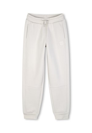Pantalon de jogging gris clair avec taille élastique et cordon, poches latérales, empiècements cousus au niveau des genoux et chevilles ajustées.