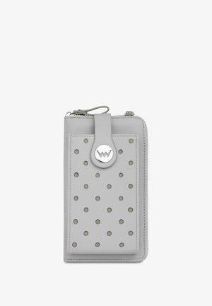 Grey leather wallet with perforated dots, a circular silver hardware detail, and a zip closure. Features a textured surface and slim design.