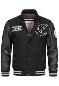 Schwarze Collegejacke mit Wollkörper und Lederärmel, gerippten Bündchen und Kragen. Verfügt über dekorative Nähte und zwei Seitentaschen.