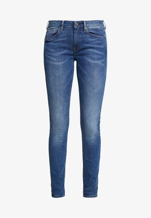 Skinny jeans in dark blue denim, featuring a mid-rise waist, five pockets, and slight fading on thighs for texture. Classic metal button closure.