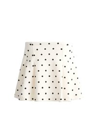 Jupe blanche trapèze à pois noirs, longueur au genou, avec une taille cintrée et un léger évasement à l'ourlet.