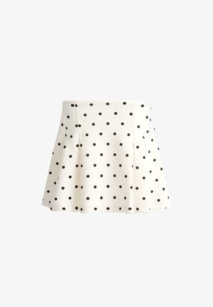 Fehér A-vonalú szoknya fekete pöttyökkel, térdig érő, szabott derékkal és enyhe bővüléssel az alsó részen.