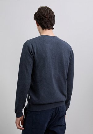 Navy blue knit sweater with long sleeves and a round neck, featuring a ribbed hem and cuffs. Soft texture with a slight sheen.