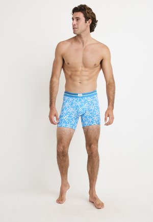 Blue boxer shorts with a white floral pattern, featuring a light blue waistband. Made of stretchable material for comfort.