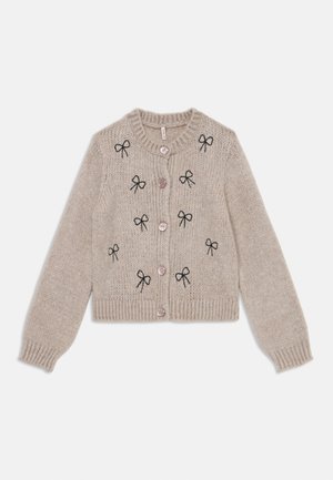 Beige strik cardigan med sort bue broderi, rund hals, lange ærmer og lyserøde knapper ned foran.