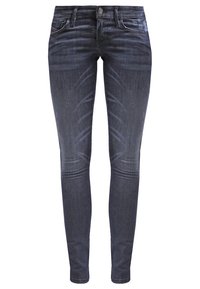 Jeans skinny de color azul oscuro en denim elástico, con cinco bolsillos, cierre de botón y un ligero desvanecimiento en los muslos para añadir textura.