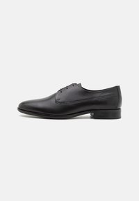 Black leather dress shoe featuring a sleek design, pointed toe, five eyelet lace-up closure, and a smooth texture with a low heel.