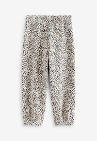 Los pantalones jogger de algodón cuentan con una cinturilla elástica, piernas ajustadas y una base beige decorada con un patrón de manchas negras en todo su exterior.