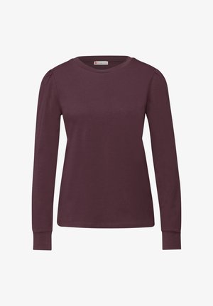 Bordowa koszulka z długim rękawem wykonana z miękkiego materiału. Posiada okrągły dekolt i marszczenia na szwach ramion.