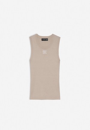 Beige sleeveless top with a fitted design, ribbed texture, and a small white logo in the center. Made from a soft, stretchy material.