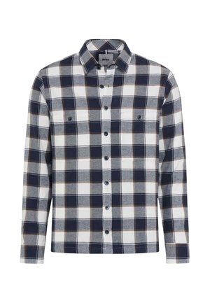 Chemise à manches longues à carreaux dans des tons bleu marine, blanc et marron. Tissu en coton avec fermeture à boutons et deux poches poitrines. Texture douce.
