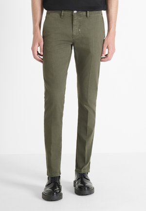 Olive green slim-fit pants made of cotton with a smooth texture, featuring a button and zip closure, side pockets, and a clean design.
