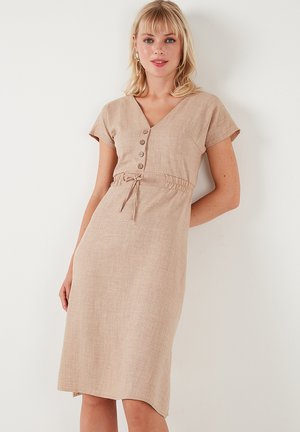 Beige linen dress with short sleeves, V-neck, button detailing, an elasticated waist, and a slightly flared hem. Smooth texture.