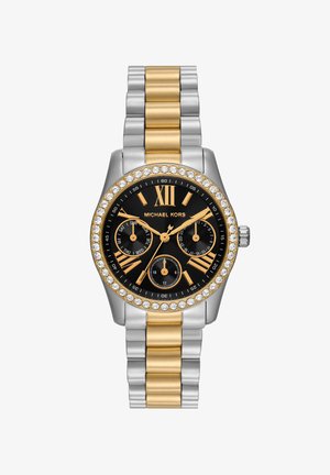 Michael Kors horloge met zwarte wijzerplaat, gouden Romeinse cijfers, drie subdials, kristallen lunet, tweekleurige zilveren en gouden metalen armband.