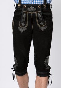 Black suede lederhosen with intricate silver embroidery and leather accents; fitted shape, knee-length, adjustable ties at hem.