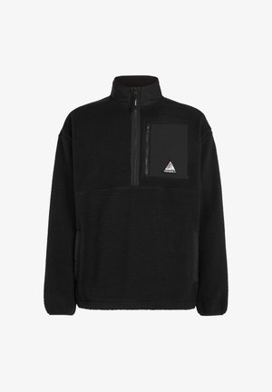 Pulover negru din fleece cu gât cu fermoar, dotat cu un buzunar pe piept din material negru și o etichetă cu logo în formă de triunghi. Material texturat moale.