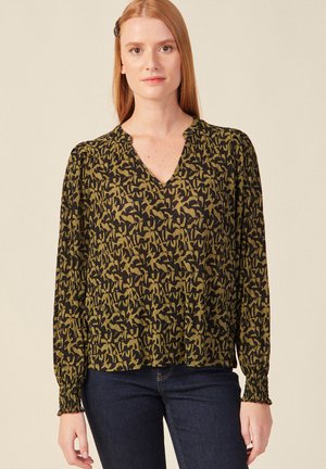 Blusa de patrón negro y verde oliva con escote en V, mangas largas y puños recogidos. Tejido ligero con un acabado texturizado.