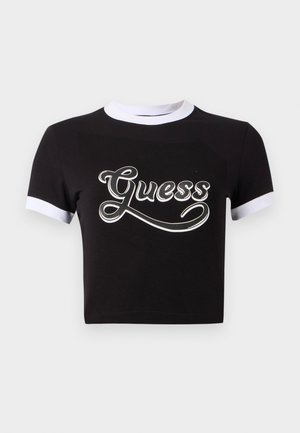 Top corto negro de algodón con acentos blancos en el cuello y las mangas. Presenta un gran logo blanco de "Guess" en el frente.
