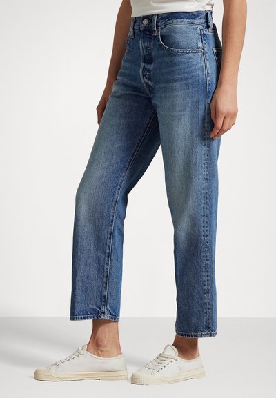 Högmidjade, ljusblå denimjeans med rak passform, med en klassisk femfickdesign och subtila slitningar på tyget.