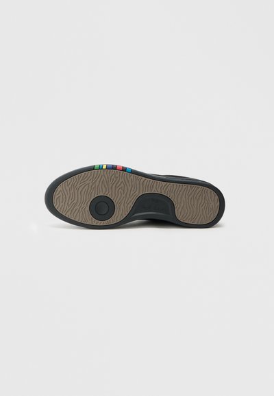 Υποδήματα με επίπεδη, μαύρη καουτσούκ σόλα με υφή καφέ μοτίβου, διακοσμημένα με πολύχρωμες ρίγες στη φτέρνα.