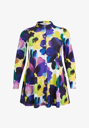 Langärmliges Hemd mit Knöpfen und ausgestelltem Saum, das ein lebhaftes Blumenmuster in Gelb, Lila, Blau, Grün und Schwarz auf weißem Hintergrund zeigt.