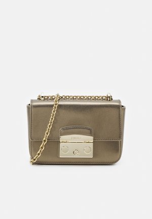 Pequeño bolso metálico de bronce con cadena dorada como correa y cierre rectangular dorado en la parte frontal.