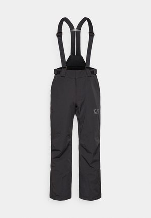 Mustad mustad püksid reguleeritavate rihmadega, millel on tekstuuriga kangas, tugevdatud õmblused ja väike logo vasakul poolel.