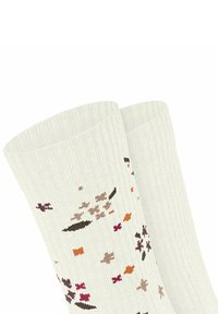Lichtgrijze geribde sokken versierd met een bloemenpatroon in paars, bruin, oranje en roze. Katoenmengsel, lengte tot halverwege het kalf.