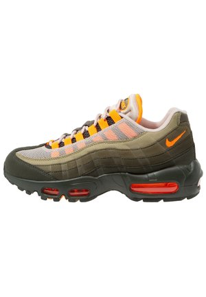 Olive green and beige Nike sneaker with orange accents, mesh panels, visible air cushioning in the sole, and laced closure.