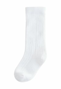 Chaussette en coton blanc avec une texture côtelée, un orteil arrondi et un talon renforcé. Design simple sans motifs ni embellissements.