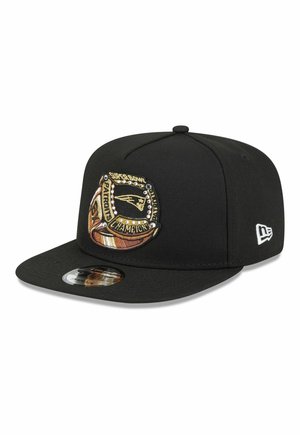 Black New Era cap with embroidered Super Bowl championship ring patch featuring the New England Patriots logo and text.