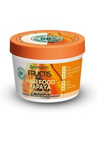 Contenitore rotondo e bianco con un coperchio arancione brillante. Presenta il testo "Hair Food Papaya" in verde e giallo, che indica formule vegane e senza silicone.