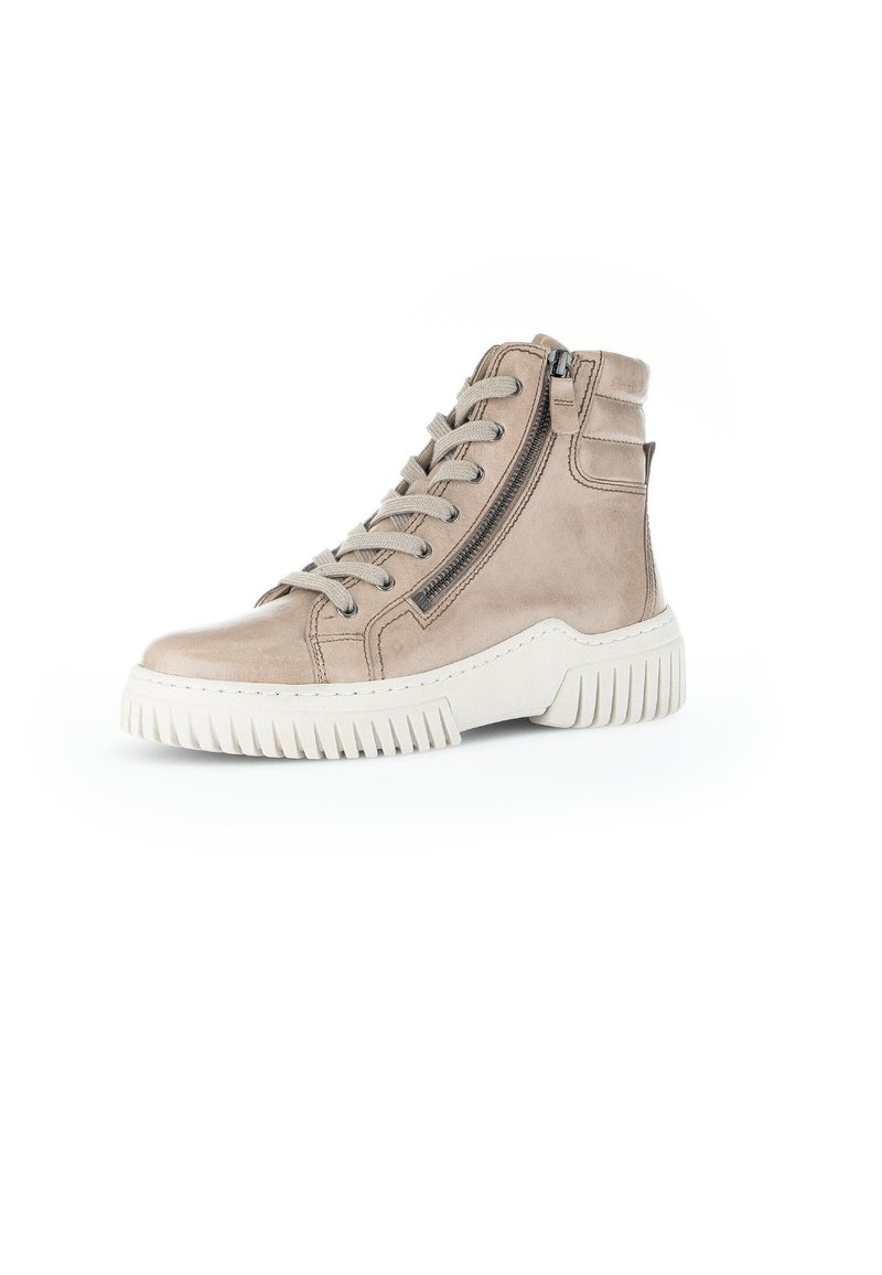 Beige high-top sneakers with a suede texture, featuring a front lace-up design, side zipper, and a chunky, ridged white sole.
