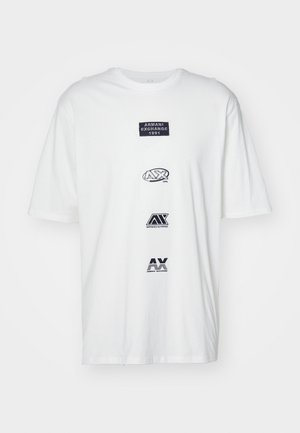 White cotton t-shirt featuring three embroidered logos: "ARMANI EXCHANGE 1991," "AX 1991," and "AX" in blue and black text. Circular neckline.
