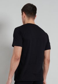 Black short-sleeve t-shirt with a classic crew neck design, made from lightweight cotton fabric, featuring a smooth texture and a fitted silhouette.