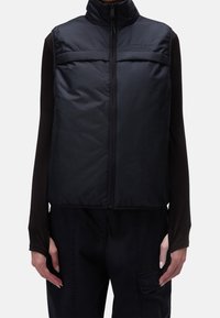 Schwarze, leichte Steppweste mit hohem Kragen, Frontreißverschluss und zwei Seitentaschen; glatte Textur mit minimalistischem Design.