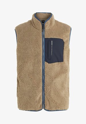 Tan fleece vest with high collar, front zipper, and navy pocket. Features plush texture and blue trim along the edges for contrast.