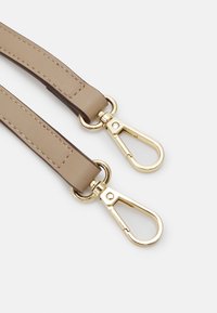 Beige leather strap with gold-tone metal clasps. Smooth texture with stitching detail along the edges. Two clasps for attachment.